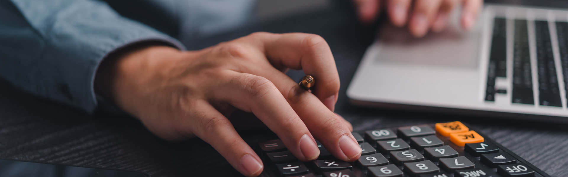 Businessman using calculator bookkeeping payroll and budget tax